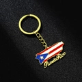 Detail of golden Puerto Rico map keychain with flag colors and artistic script text - Gold C