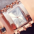 Close-up of a women's rose gold chain watch featuring a rectangular dial on the wrist - White Dial Rose Gold Strap Without Diamonds