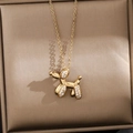 Detailed macro of golden balloon dog pendant necklace with micro-pave cubic zirconia stones - Golden Balloon Dog