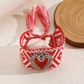 Detail of red and white woven bracelet with a heart crown charm and boho tassels - Red and White Woven Bracelet