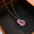Detailed close-up of a silver gourd necklace with pink gems and diamonds in a jewelry box - Gourd Necklace - Silver