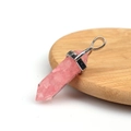 Pink hexagonal crystal column pendant with metallic clasp on a wooden display - Resin Pink Jade