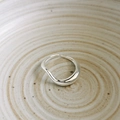 Macro detail of silver wavy irregular open ring on a textured ceramic surface - Adjustable Open / Silver Twisted Line Ring