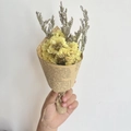 Detailed view of mini handmade yellow flower bouquet wrapped in vintage newspaper kraft paper - Vintage Mini Yellow Forget-me-not