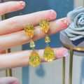 Detailed close-up of yellow teardrop-shaped drop earrings with three-tier crystal stones - Yellow Zirconia