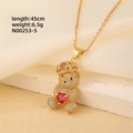 Detail of gold crown bear pendant necklace with red heart stone on elegant silk fabric - Gold - Crown Red Heart Bear