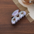 Chic lavender bow hair claw clip featuring green heart cutouts on a wooden table - Hollow Heart Half Round Claw / Purple