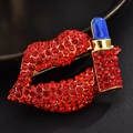 Detailed view of luxury red crystal lips and blue lipstick brooch with gold finish - Lipstick Lips Red