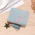 Light blue faux leather short wallet with floral embroidery and tassel on wood background - Blue (Flower Embroidery)