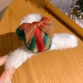Close-up of plush Christmas gift box hair claw clip with festive gold bow and red ribbon - Christmas Gift Box