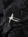 Detail view of silver stainless steel luminous star ring on dark textured paper background - NR305 Lightning