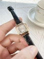 Close-up of women's vintage square watch with black crocodile leather strap and gold case - Black