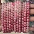 Macro shot of multiple high-quality natural pink crystal round beads for DIY jewelry - Natural Gradient Sakura Rain