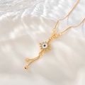 Macro shot of evil eye pendant with cubic zirconia accents and gold bead tassels - XL012-Tassel Eye