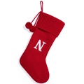 Red knit Christmas stocking featuring a white letter N patch and decorative pom poms - Letter N / Red