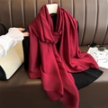 Detail of elegant dark red silk satin scarf with a glossy finish draped on a hanger - Burgundy