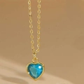 Elegant gold chain necklace with a heart-shaped blue zircon pendant in a bezel setting - Lake Blue