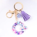 Detail of resin letter C keychain with colorful stones, purple tassel, and golden hardware - Letter Q