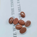 Close-up of oval goldstone cabochons with sparkling gold flecks for jewelry inlay - 10*14mm / Goldstone (Synthetic)