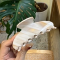 Detail of a large cream acetate hair claw clip with marble pattern for thick hair - Large / Milk White Gold Slanted Stripes