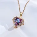 Macro shot of 18K gold plated heart pendant with purple iridescent zircon and white crystals - Heart of the Ocean