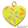 Macro shot of gold-plated heart pendant with neon green and orange enamel and zircons - Gold Yellow Orange Painted Heart