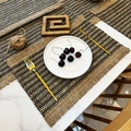 Woven jute placemat with black geometric patterns and decorative tassels for dining tables - Jute Fringe Mixed Black
