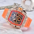 Detailed macro of rose gold tonneau watch case with crystal bezel and orange rubber strap - Orange Dial Rose Gold Case Orange Strap