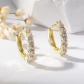 Macro detail of gold hoop earrings featuring sparkling cubic zirconia on a minimalist background - Classic Pave Zirconia Hoop Style (EH848)