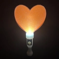 Macro shot of an orange heart glow stick with glitter particles and white handle - Thickened Heart Wand Orange