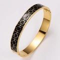 Polished gold stainless steel bangle with black enamel geometric patterns and clasp - Black Enamel