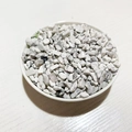 Natural white and gray crushed crystal stones in a white bowl for DIY decoration - Howlite