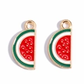 Macro detail of two red enamel watermelon slice charms with gold alloy metal edges - Watermelon