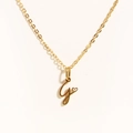 Detailed close-up of golden necklace with initial J pendant and small heart charm - Gold - Letter G