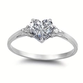 Macro shot of silver heart ring with large heart-cut stone and side diamonds - US 6 / White