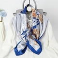 Close-up of elegant floral silk scarf with blue border styled on a white shirt - Royal Blue Floral