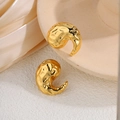 Irregular hammered gold titanium stud earrings with textured surface on silk background - Textured Comma