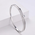 Silver hollow bangle with central round crystal and pave setting in polished finish - Steel