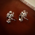 Close-up of vintage silver floral earrings with double heart petals on leather background - Silver Flower Studs / Silver (Silver Earring Post)