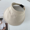 Detailed view of beige sun visor featuring woven straw trim and adjustable metal buckle - Beige