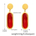 Detail view of 18K gold plated stainless steel earrings with red faceted Czech glass stones - Oval Dangle Style (TXF272) / Gold Red