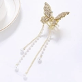 Elegante fermaglio a farfalla dorato con cristalli e nappe di perle pendenti - Oro