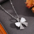 Detail of silver bow pendant necklace featuring white mother of pearl and zircon stones - Silver White Shell Inlaid Diamond Bowknot Necklace