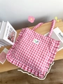 Detail of pink gingham ruffle tote bag with fun party embroidery on wooden surface - Ruffle Checkered Shoulder Bag-Light Pink