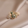 Golden bee brooch pin with sparkling white rhinestones and emerald green crystal gems - 520# Bee