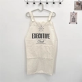 Detail of cream cotton linen apron featuring executive chef print and large pockets - EXECUTIVE White