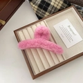 Detailed close-up view of a pink plush hair claw clip on an elegant display tray. - L / Pink