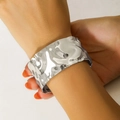Silver wide hammered cuff bracelet in punk style worn on a model wrist for fashion - Silver