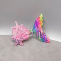 Detail of sequin mermaid tail and pink starfish hair clips with a shell design - Dark Rainbow Mermaid