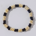 Minimalist hand-strung bracelet with glossy black beads and gold-plated accents - Black & Gold